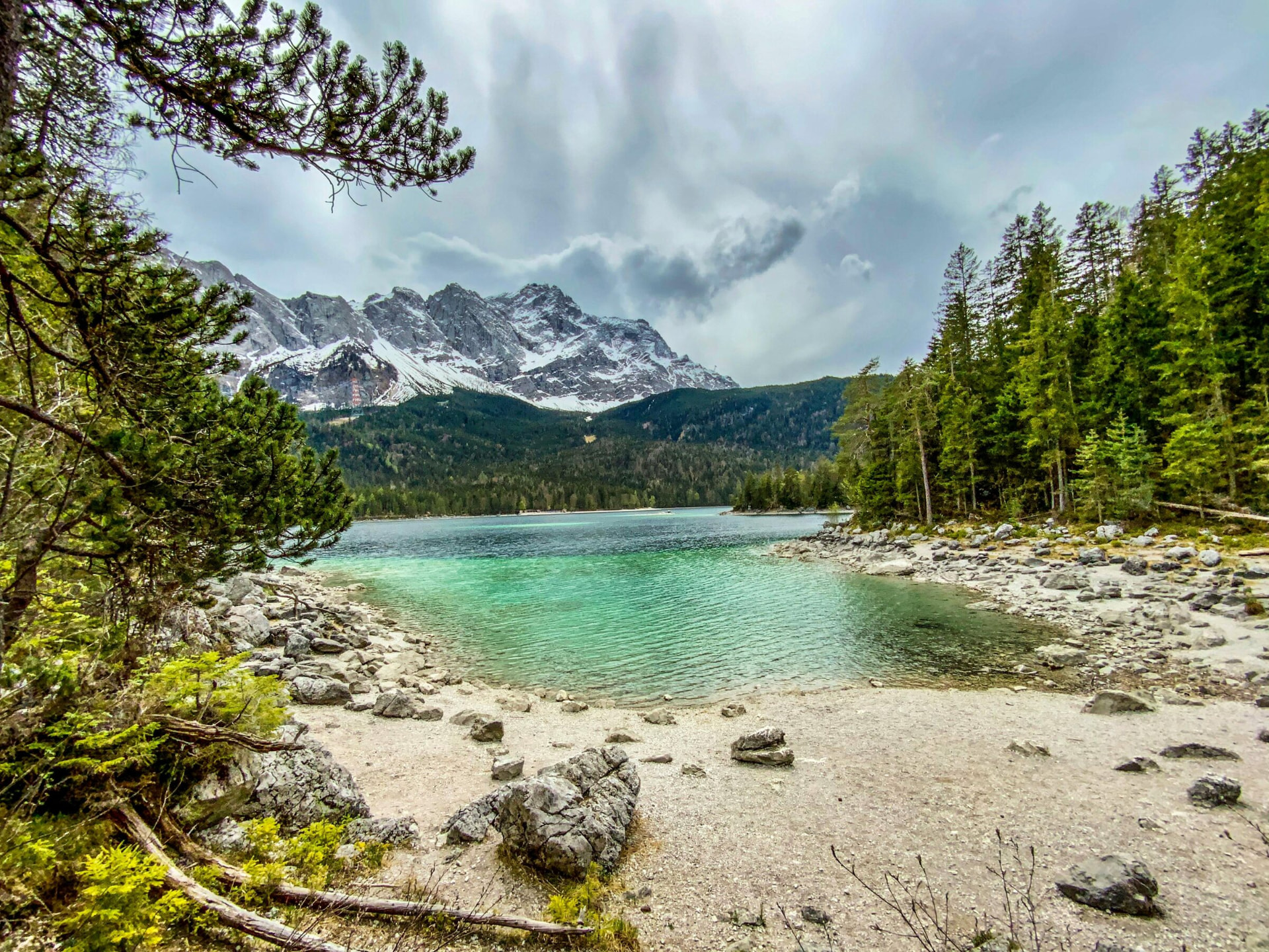 Turquoise Eibsee lake with the snow-capped Zugspitze massif behind it, Bavaria