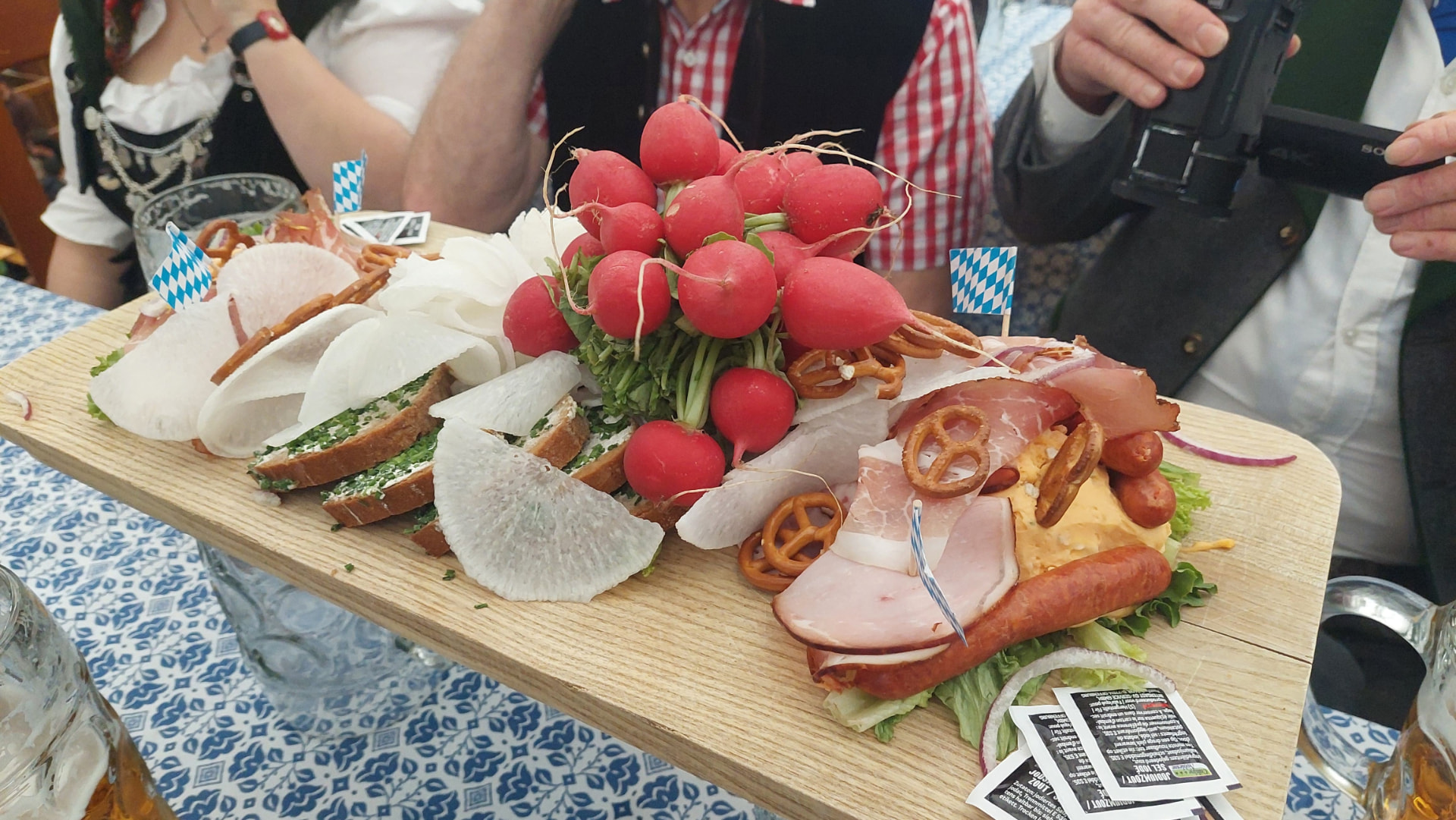 Bavarian Brotzeitbrett with cold cuts, cheese, radishes, and small pretzels at Oktoberfest.